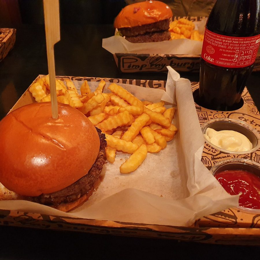 A burger, fries and dips on a tray