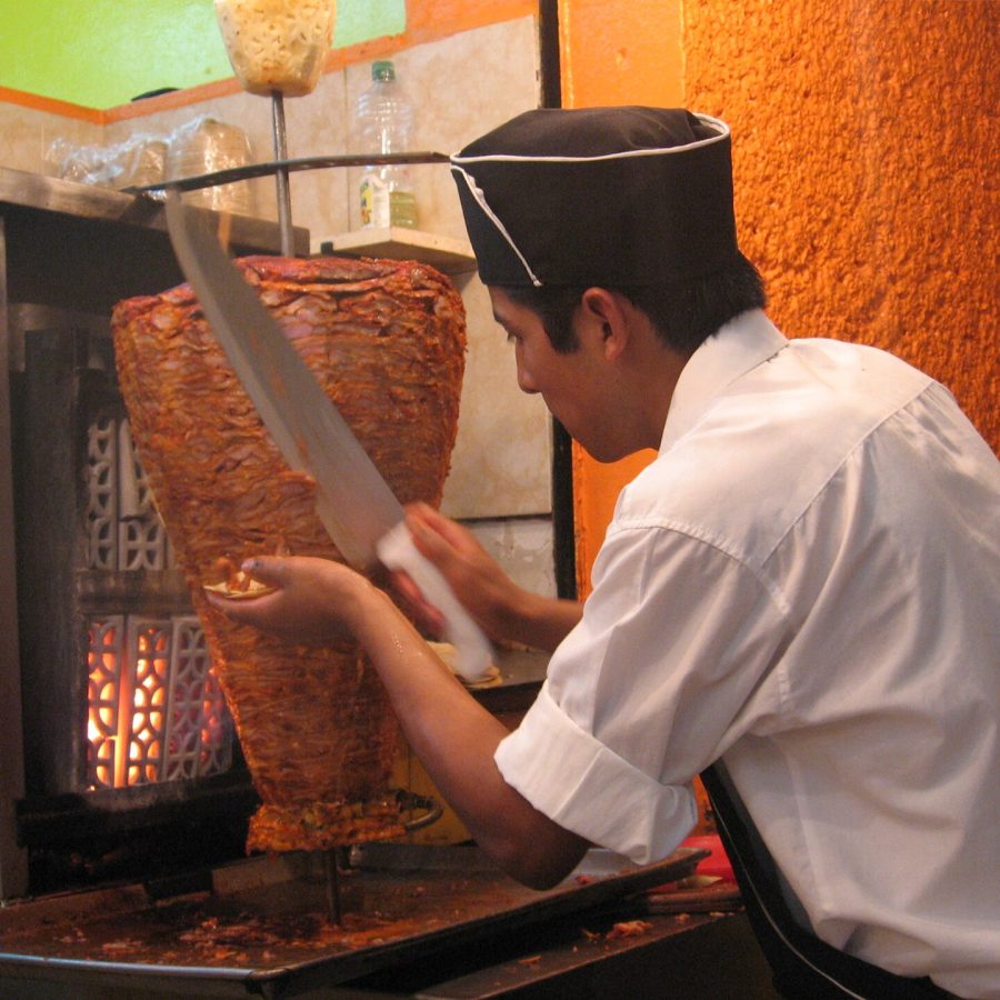 A cook slicing meat from the shawarma spit